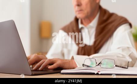 Unrecognizable Senior Businessman Working On Laptop Sitting In Office, Cropped Stock Photo
