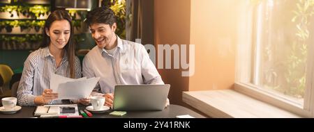 Millennial coworkers having business lunch at cafe Stock Photo