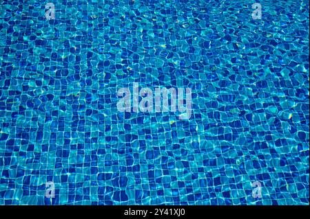 Swimming Pool Surface With Light Reflection and Water Ripple Patterns Stock Photo