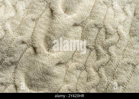 Handmade white knitted wool blanket. Background textures. Stock Photo