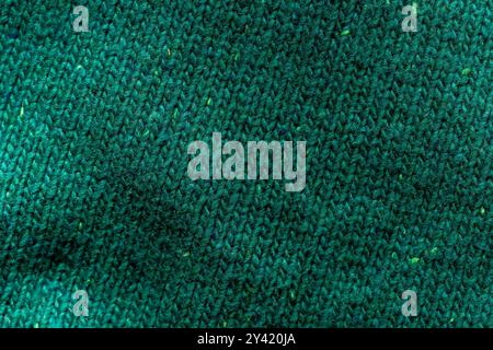 Handmade turquoise knitted wool blanket. Background textures. Stock Photo