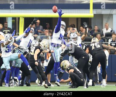 Irving, United States. 15th Sep, 2024. New Orleans Saints place kicker Blake Grupe (19) connects on an extra point attempt over Dallas Cowboys defensive end DeMarcus Lawrence (90) during a National Football League contest at AT&T Stadium on Sunday, September 15, 2024 in Irving, Texas. (Photo by Peter G. Forest/Sipa USA) Credit: Sipa USA/Alamy Live News Stock Photo