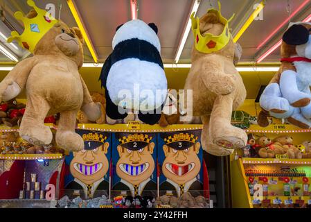 Giant stuffed animal toy prizes on funfair fairground stall  Stock Photo