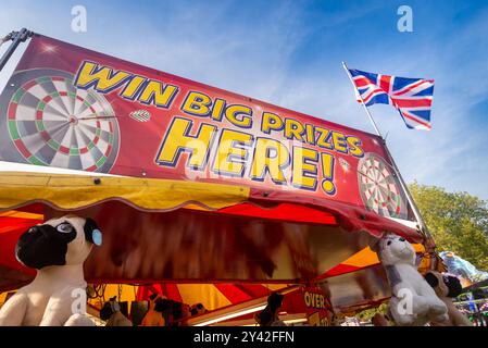 Win Big Prizes Here banner sign on prize stall at British funfair  Stock Photo