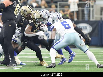 Irving, United States. 15th Sep, 2024. New Orleans Saints running back Alvin Kamara (41) tries to get past Dallas Cowboys safety Donovan Wilson (6) during a National Football League contest at AT&T Stadium on Sunday, September 15, 2024 in Irving, Texas. (Photo by Peter G. Forest/Sipa USA) Credit: Sipa USA/Alamy Live News Stock Photo