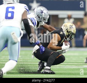 Irving, United States. 15th Sep, 2024. New Orleans Saints wide receiver Chris Olave (12) catches a pass against Dallas Cowboys safety Donovan Wilson (6) during a National Football League contest at AT&T Stadium on Sunday, September 15, 2024 in Irving, Texas. (Photo by Peter G. Forest/Sipa USA) Credit: Sipa USA/Alamy Live News Stock Photo