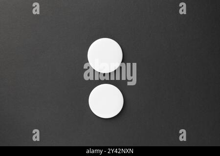 Blank white button badges on black background, top view. Mockup for design Stock Photo