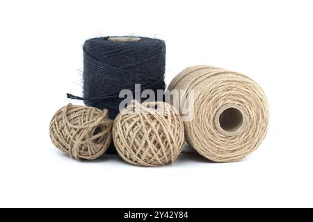 Assorted jute and twine spools on a white background showcasing natural fiber materials for crafting and packaging Stock Photo