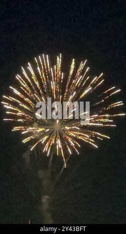 FIREWORKS OVER LAKE WITH BOAT Stock Photo