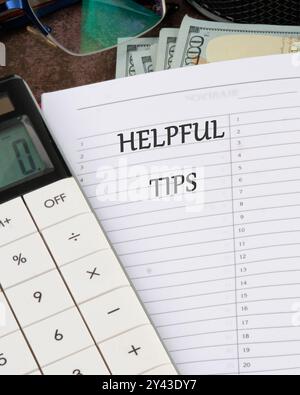 Helpful Tips words in a notebook in a ruler on a blank sheet Stock Photo