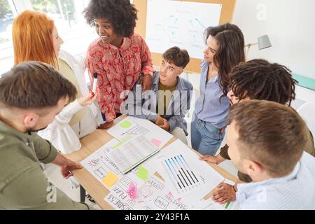 Business Team Collaborating on Documents During Office Meeting Stock Photo
