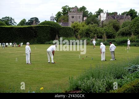 Elderly People Playing a Game of Croquet on the Lawn at Levens Hall Manor House Gardens in the Lake District National Park, Cumbria, England, UK. Stock Photo