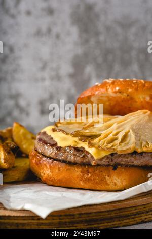 Hamburger with oyster mushrooms and cheddar cheese on a wooden cutting board Stock Photo