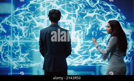 Engineers use VR headset and AR hologram, looking at AI neural networks modeled after human brain. Admins using artificial intelligence, virtual and augmented reality tech to look at data, camera B Stock Photo