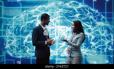 Computer scientists use AI neural networks modeled after human brain to solve complex problems. Startup employees using artificial intelligence to look at data and complete tasks, camera B Stock Photo