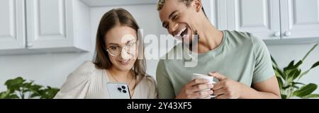 Friends enjoying a lighthearted conversation while sharing a drink. Stock Photo