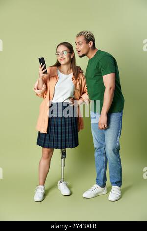 Two friends share a moment while interacting over a smartphone. Stock Photo