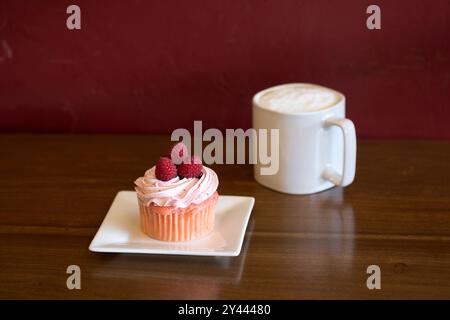 Cupcake and a caffe latte on a table Stock Photo