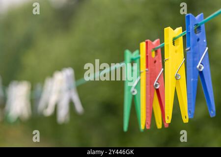 Plastic Colourful clothes pegs on a washing line Stock Photo