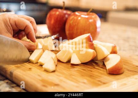 Apples getting cut up on a wooden board Stock Photo
