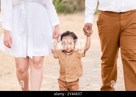 Close up of son holding parents hands Stock Photo