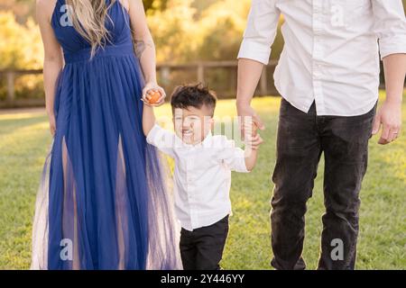 Family holding hands and smiling Stock Photo