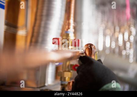 Plumber working with copper water pipes and fittings on tankless Stock Photo