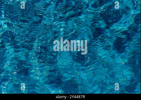 Swimming Pool Surface With Light Reflection and Water Ripple Patterns Stock Photo