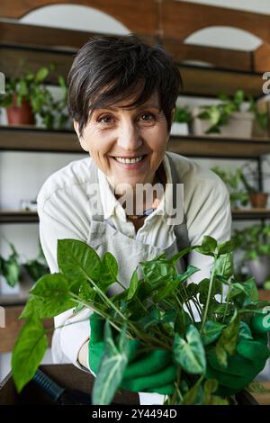 A joyful gardener tending to her vibrant plants with care and passion. Stock Photo