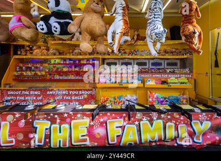 Giant stuffed animal toy prizes on funfair fairground stall  Stock Photo