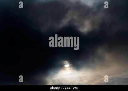 Sun covered in dark clouds Bawdsey Suffolk Stock Photo