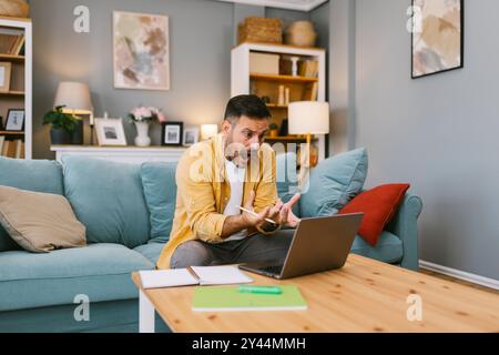 Stressed man dealing with a problem on his laptop Stock Photo
