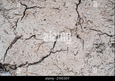 Old cracked wall made of orange clay and straw. Stock Photo