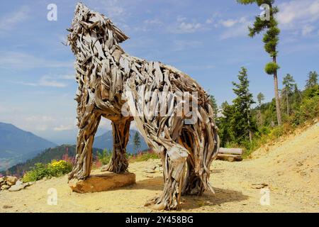 View of the wooden sculpture 'Lupa del Lagorai' by the artist Marco Martalar, located in Monte Vetriolo. August 7, 2024, Monte Vetriolo, Levico Terme, Stock Photo