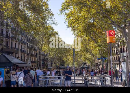 Barcelona, Spain - September 15, 2024: La Rambla is alive with activity as people walk along its busy path, surrounded by shops, street performers, an Stock Photo