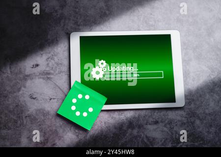 Top view of digital tablet with updating software on screen. System engineer and programming. Software apps developer. Stock Photo