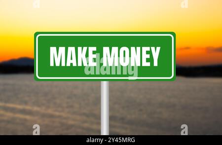 Make money message written on green sign on blurry lake background at sunset. Conceptual make money symbol. Copy space. Stock Photo