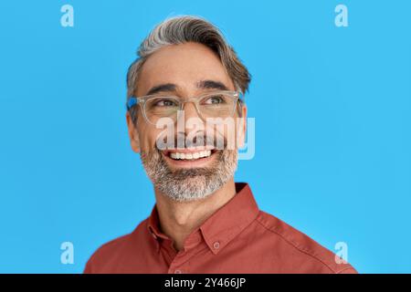 Happy smiling middle aged man wearing glasses isolated on blue background. Stock Photo