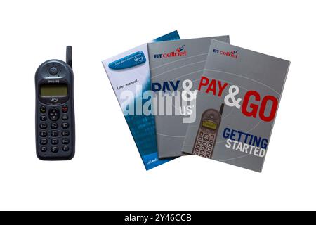 Old BT Cellnet Pay & Go Philips Savvy mobile phone, cell phone, with Getting Started booklets books isolated on white background Stock Photo