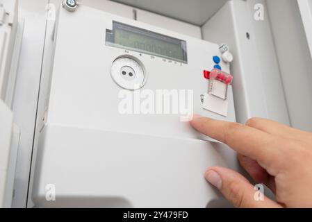 Man checking household electricity meter, close up Stock Photo