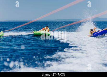 Adventurous speedboat tubing on a sunny day with friends having fun Stock Photo