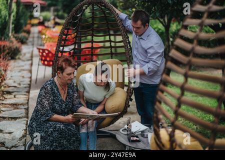 Family bonding with boy with Down syndrome and disabled girl outdoors Stock Photo