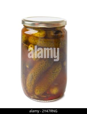 Canned cucumbers in a closed glass jar, isolated on a white background, close-up. Pickled gherkins. Stock Photo