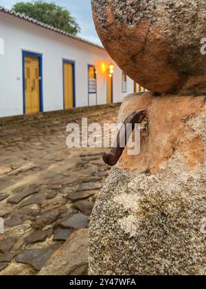 Paraty, Brazil. Detail of a stone wall of colonial-era houses in the historic center. Stone street. Selective focus. Stock Photo