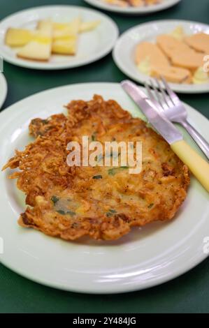 Traditional Andalusian dish from deep roasted potato and seafood, Tortillitas de Camarones, Shrimp Fritters served in old tavern as tapas, Sanlucar de Stock Photo