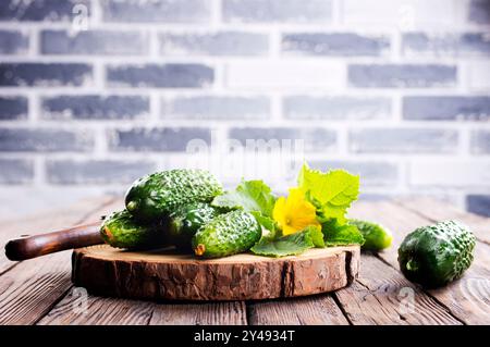 cucumbers on wooden cutting board, fresh organic vegetable food Stock Photo