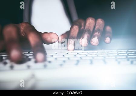Hacker, coding and hands in night with keyboard, typing and information technology, criminal and working late. Person, illegal and programming of Stock Photo