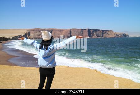 Female Traveler Being Impressed by Stunning Landscape of Paracas National Reserve, Known as Where the Desert Meets the Ocean, Ica Region, Peru, South Stock Photo