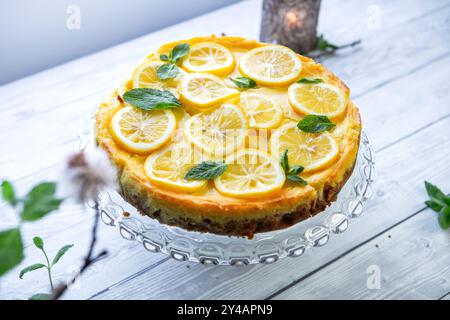 Light, refreshing lemon tart or lemon cake garnished with mint and lemon slices Stock Photo