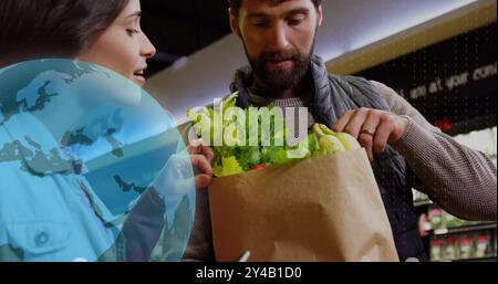 Image of data processing with icons over caucasian couple grocery shopping Stock Photo